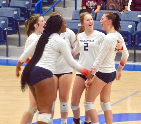 Madisonville celebrates after defeating Palestine in straight sets in the Bi-District round of the playoffs in Crockett Nov. 2. CAMPBELL ATKINS