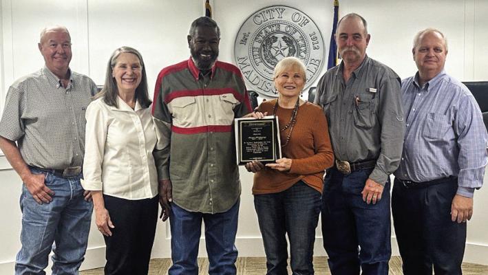 From left to right, Charles Nash, Susan McMahan, Charles Price, Karen Hadaway, Stephen Petri, and Joel Clark, during the Bedias Creek SWCD, with the group giving Karen Hadaway a plague for her time served on the board of directors.