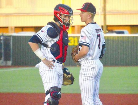 District 18-4A Pitcher MVP Rayce Hudson discusses strategy with his catcher and the district’s Defensive MVP Cody Borgfeld during a home Mustangs in 2022. CAMPBELL ATKINS